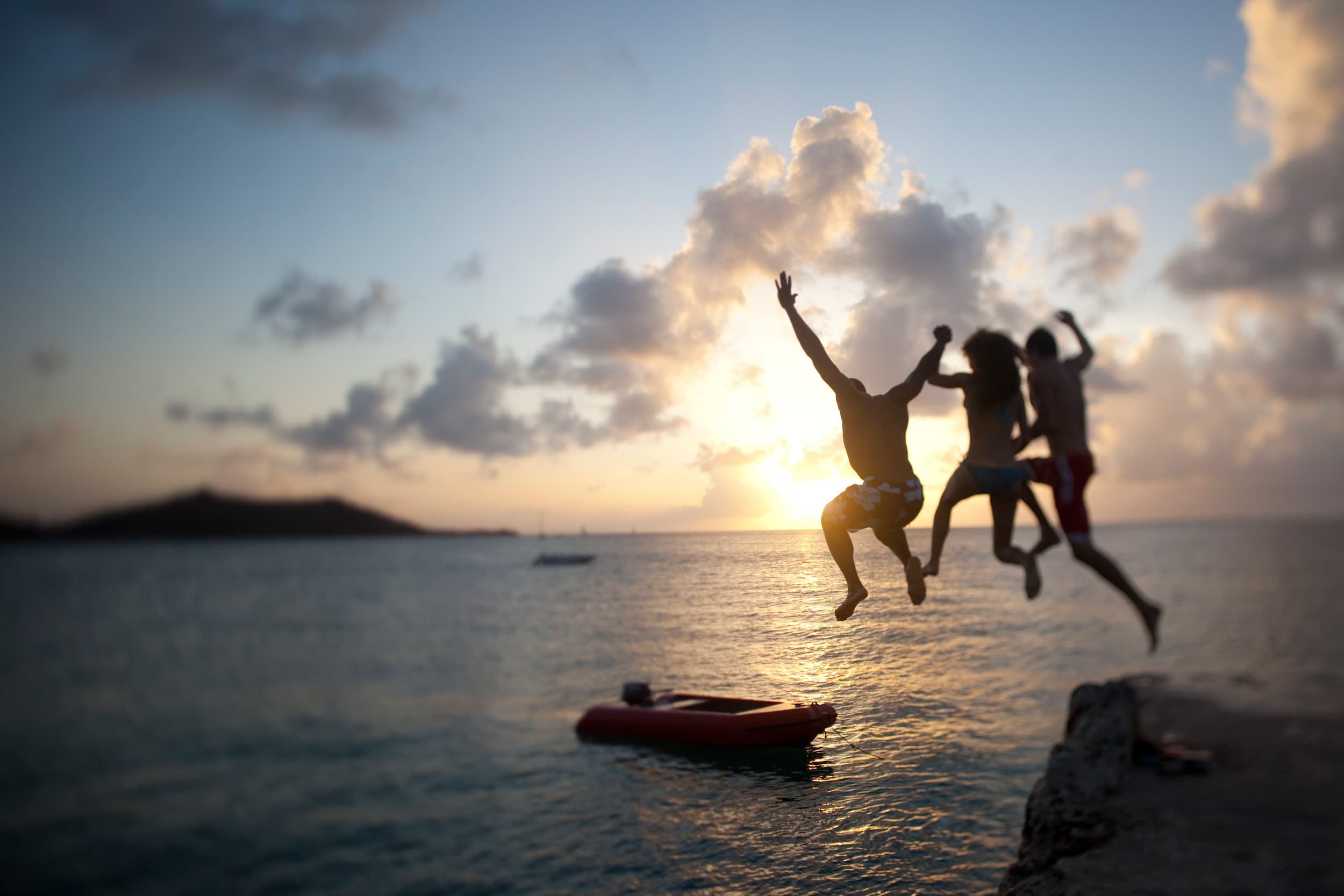 Sxphi Philipsburg Jumping In The Sea, Dusk © St. Maarten Tourist Bureau